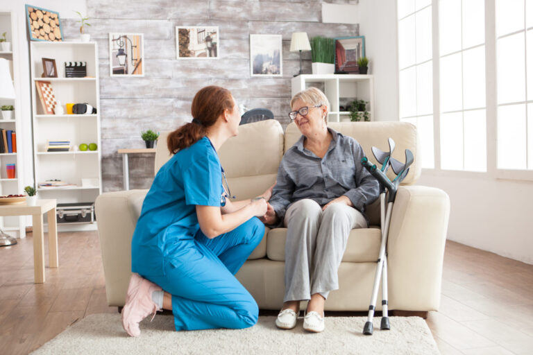 A support worker sitting with an older woman at home