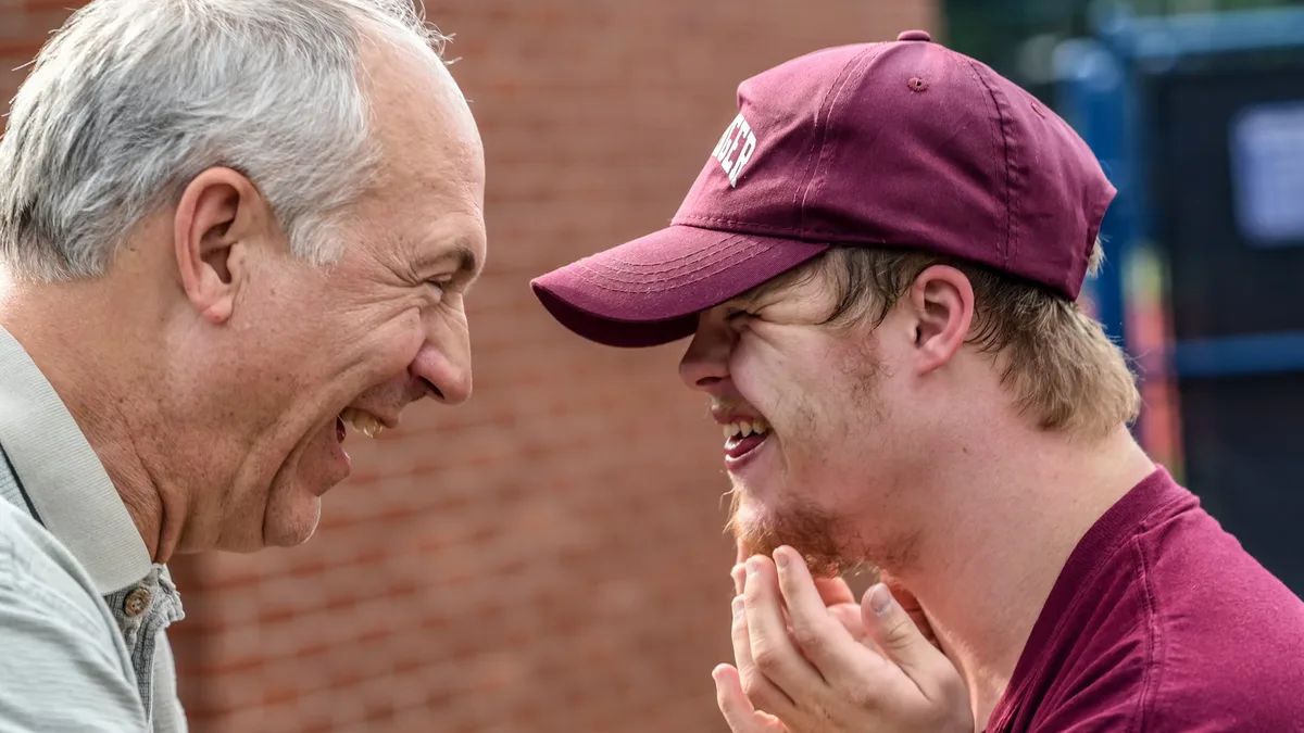 A Tenax Supports participant sharing a laugh with a mentor as part of their employment journey