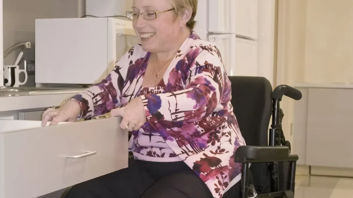 A Tenax Supports participant practising everyday living skills in the kitchen